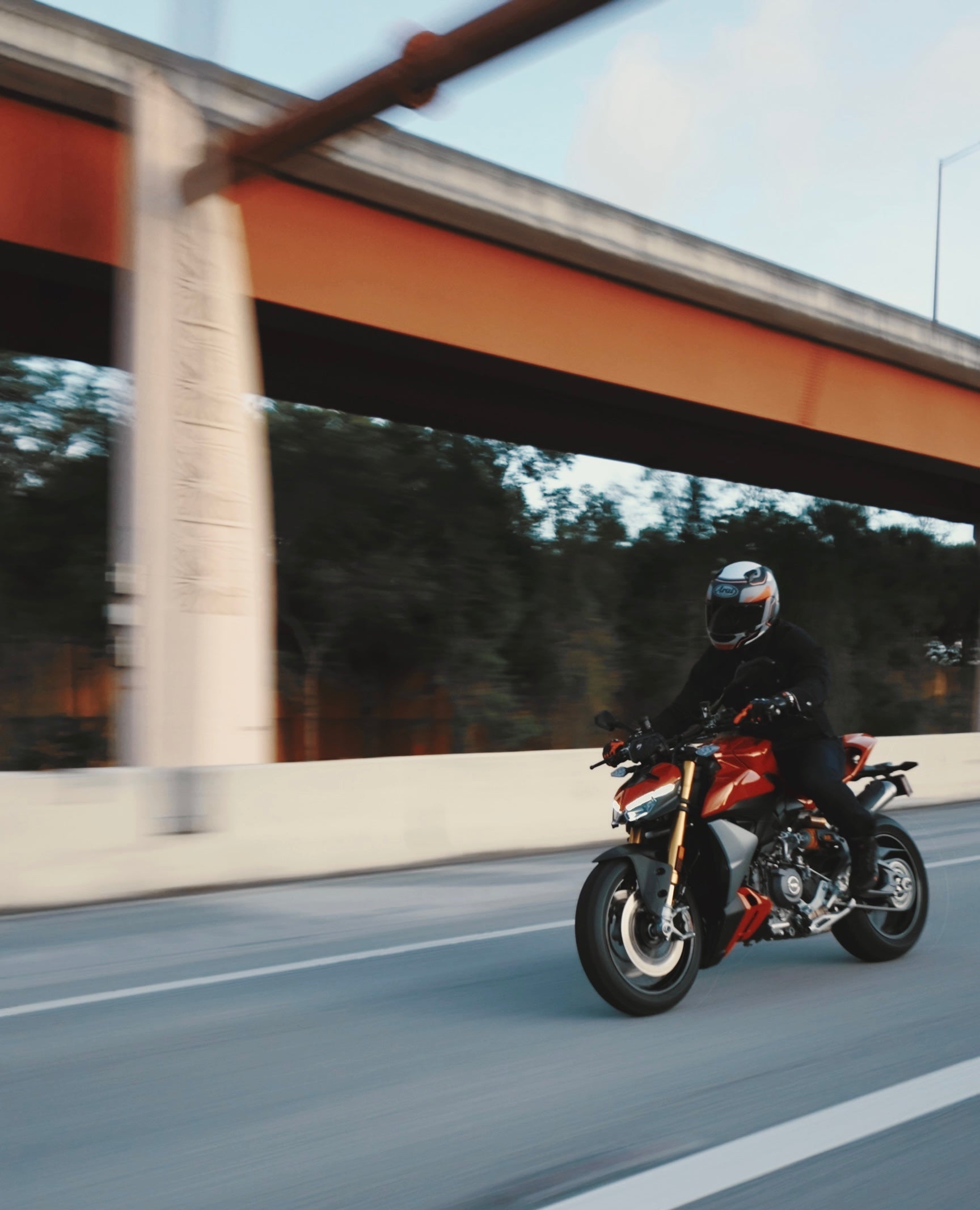 Person riding a motorcycle on a road with a blurred background